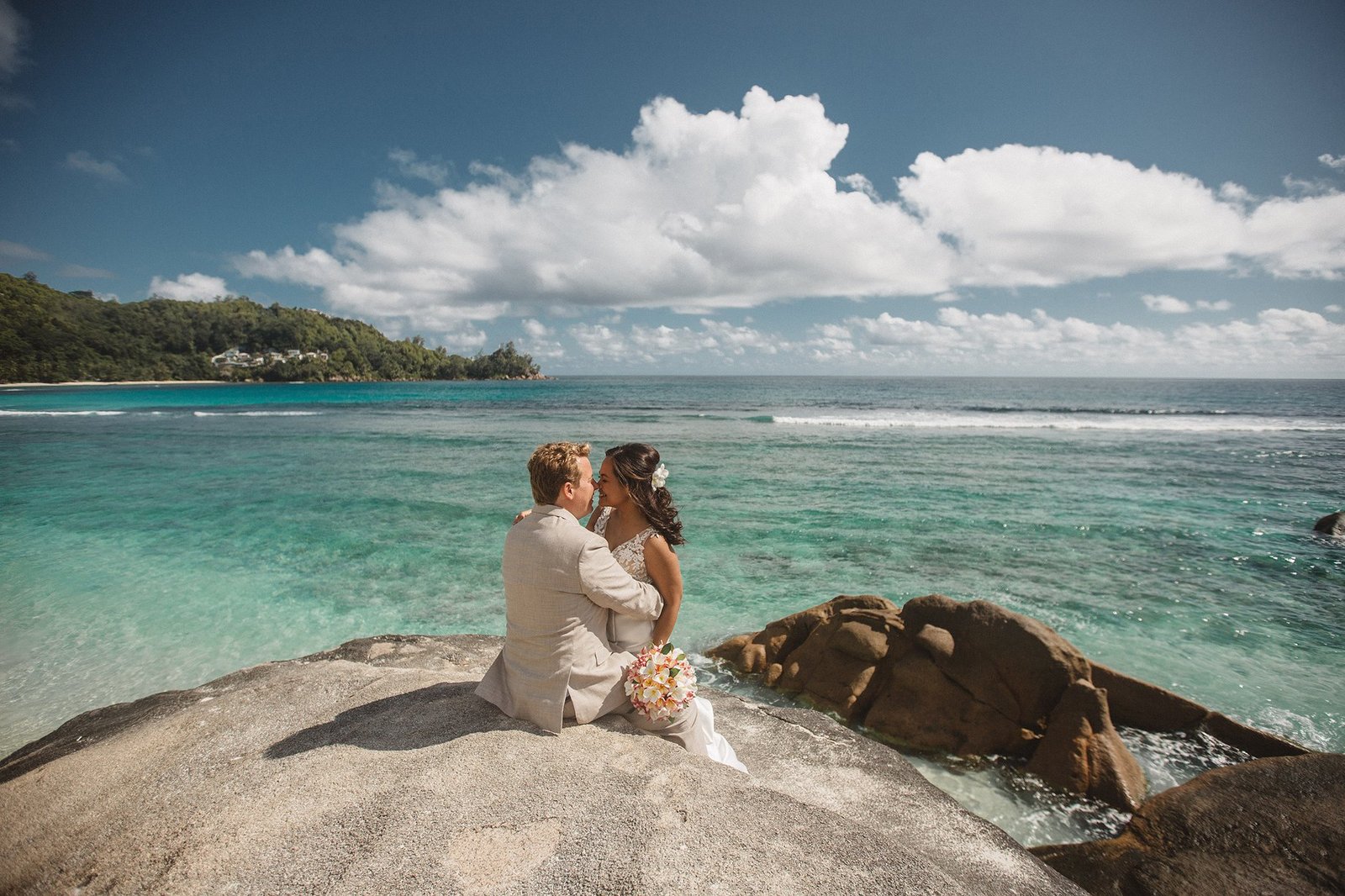 Editorial bride portrait in white against Seychelles turquoise water