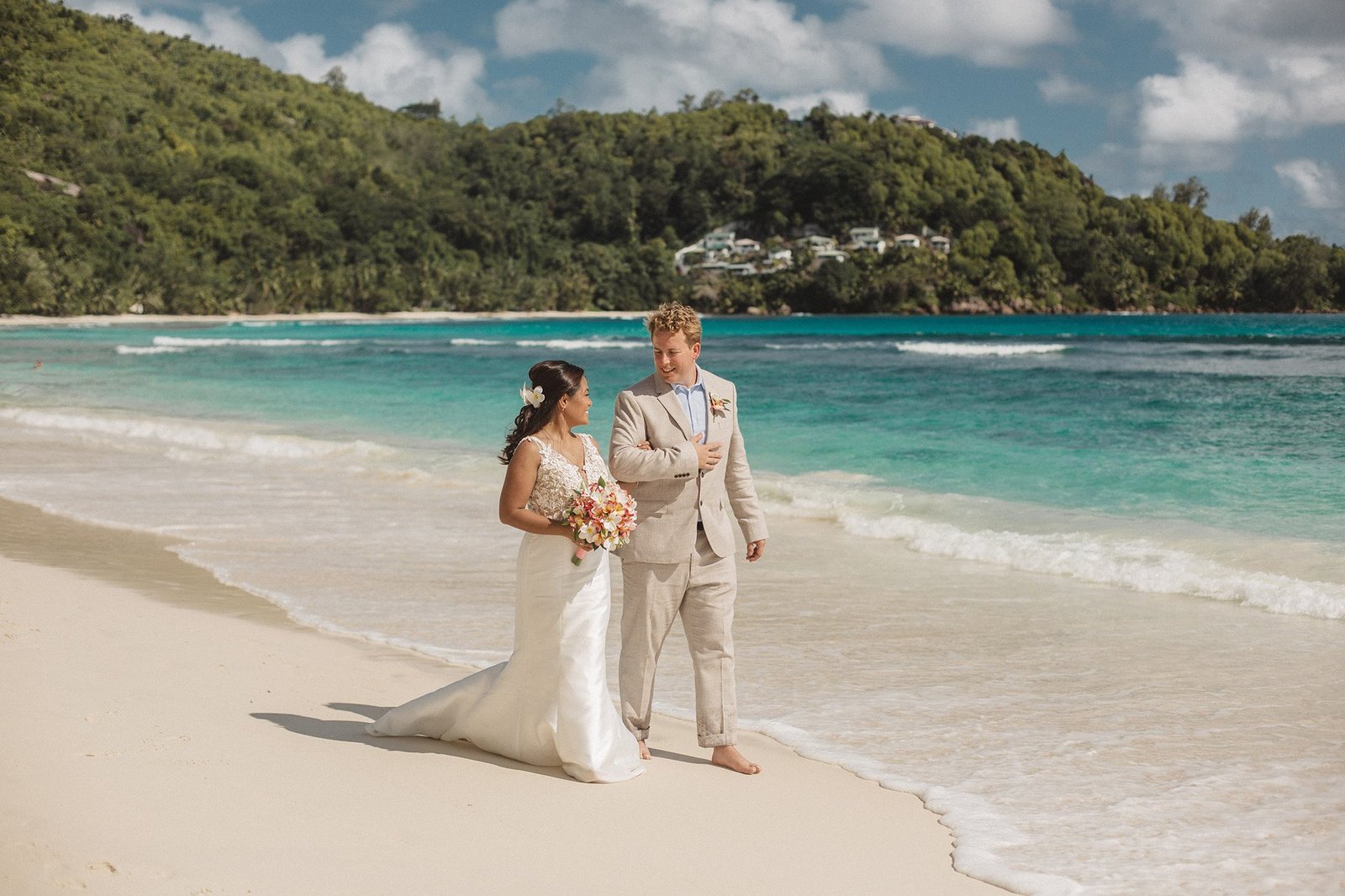 Cinematic drone shot of a wedding ceremony on a Seychelles beach with turquoise water